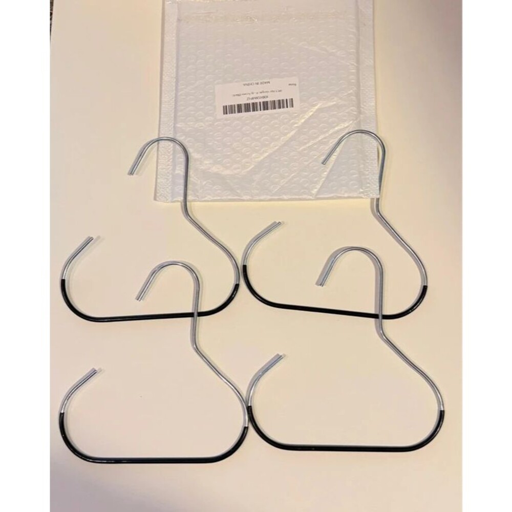 Set of 4 metal hat hangers, new and never used. Black and silver design.
